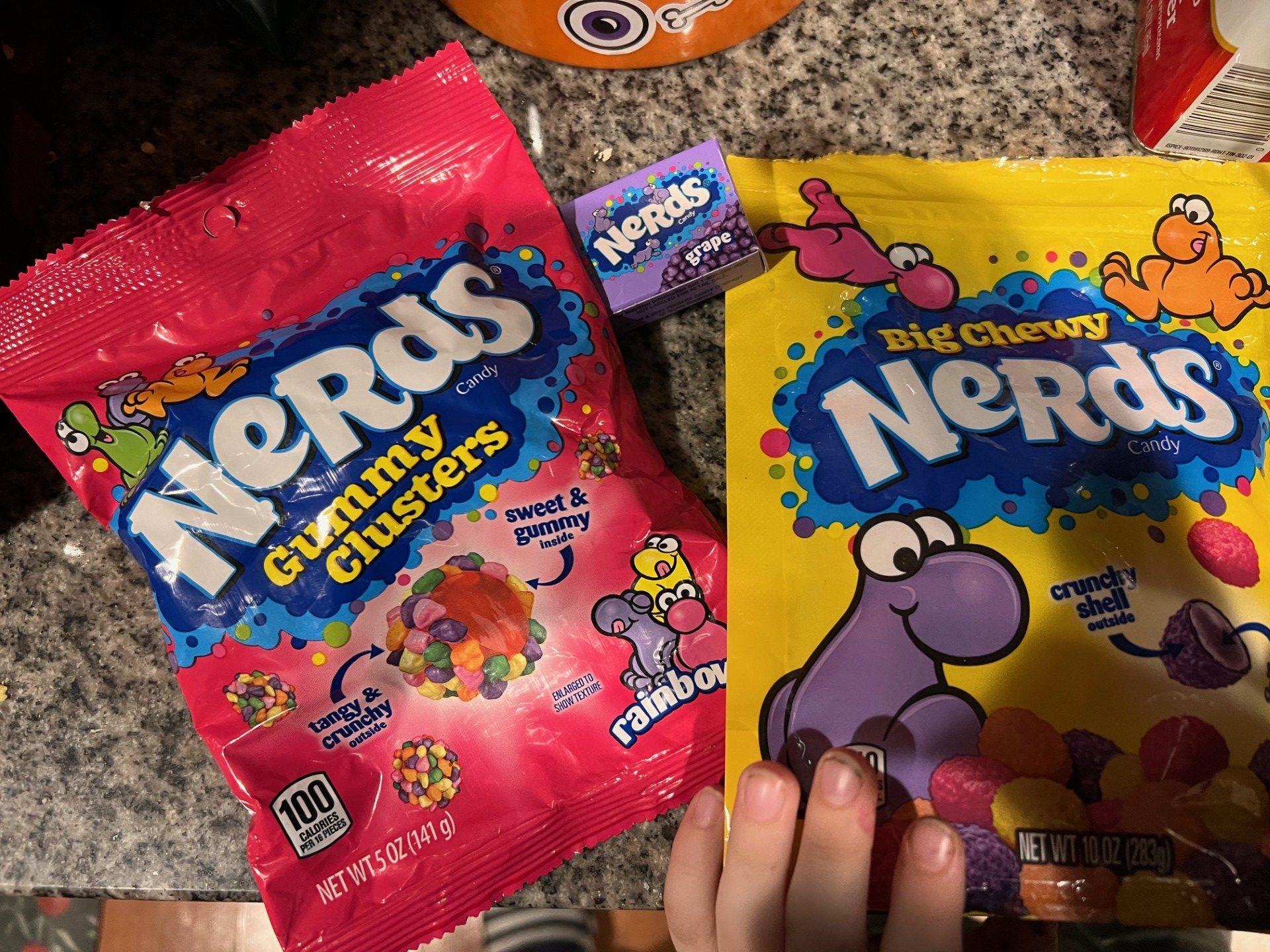 Photo of child grabbing Nerds candy, an analogy to the scammers who commit scams and frauds